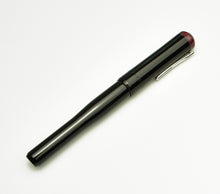 Load image into Gallery viewer, The Franklin-Christoph Model 02 Intrinsic in Black &amp; Cinnamaroon with #6 nib and silver clip rests on a white background.