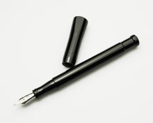 Load image into Gallery viewer, Franklin-Christoph Model 50 Grandis Fountain Pen - Solid Black, uncapped with shiny nib, on a white surface.