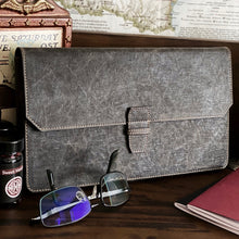 Load image into Gallery viewer, A New Penvelope 12 NWF by Franklin-Christoph, glasses, and a red notebook sit on a vintage desk with a map behind.