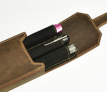 Load image into Gallery viewer, The Franklin-Christoph New Penvelope 3 in boot brown leather holds three pens, capped in pink, black, and silver.
