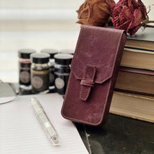 Load image into Gallery viewer, Franklin-Christoph New Penvelope 3 NWF in maroon with removable slots, shown on a desk among books and ink bottles.