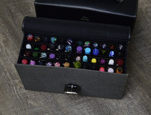 Load image into Gallery viewer, The Franklin-Christoph Christoph 48 Pen Case displays colorful, patterned fountain pens in rows on a wooden floor.