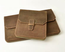 Load image into Gallery viewer, Three Franklin-Christoph New Penvelope 12 Boot Brown Leather cases are stacked on a white background.