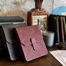 Load image into Gallery viewer, Leather journals, books, and a New Penvelope 6 NWF by Franklin-Christoph sit with papers, candle, map, and lighter.