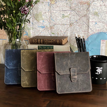 Load image into Gallery viewer, Four leather journals on a desk; map, books, flowers, and Franklin-Christoph New Penvelope 6 NWF in the background.