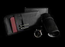 Load image into Gallery viewer, A Franklin-Christoph EDC Travel Wallet, black pen case, two pens, a red note, and a watch on a black background.