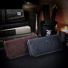 Load image into Gallery viewer, Two Franklin-Christoph 4 Nib Cases sit by books, pens, and a candle—ideal for storing your favorite nibs in style.