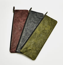 Load image into Gallery viewer, Three slim Franklin-Christoph NWF pencil pouches in distressed red, dark gray, and olive green leather with zippers.