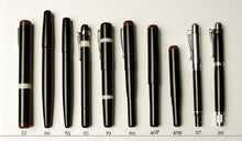 Load image into Gallery viewer, Ten Franklin-Christoph 1 F-C fountain pens with red or silver accents are arranged for comparison on a white background.