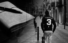 Load image into Gallery viewer, Black and white double exposure: a man in a Vagabond 3 jersey walks, clutching his Franklin-Christoph canvas notebook cover.