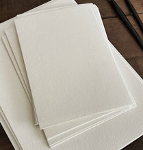 Load image into Gallery viewer, Franklin-Christoph Water Color Paper - Loose Leaf sheets rest on wood beside two black pencils.