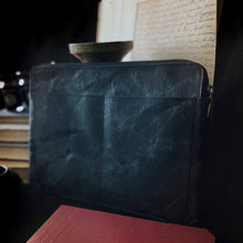 Load image into Gallery viewer, A Franklin-Christoph Gear Bag sits in front of a travel organizer and a stack of handwritten script and books.
