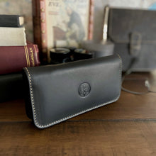 Load image into Gallery viewer, A Franklin-Christoph 4 Nib Case rests on a table with books, vintage decor, and fountain pen accessories.