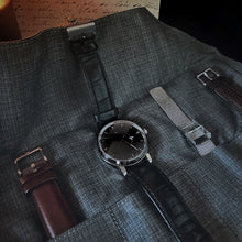 Load image into Gallery viewer, Franklin-Christoph 5 Watch Roll in black leather &amp; suit grey, with a black watch, extra straps, and a handwritten letter.
