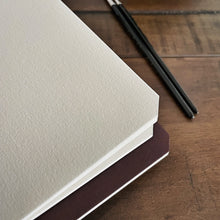 Load image into Gallery viewer, A stack of two Franklin-Christoph Water Color Paper - VN Refills with black art pens on a wooden table—perfect for travel.