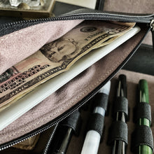 Load image into Gallery viewer, A Franklin-Christoph Currency Case - Leather holds a $50 bill, a white card, and pens organized in loops.