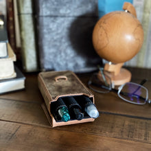 Load image into Gallery viewer, Franklin-Christoph New Penvelope 3 Boot Brown Leather pen case on a desk with books, globe, and glasses behind.