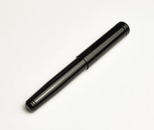 Load image into Gallery viewer, A closed Franklin-Christoph Model 20p Classic Black fountain pen lies diagonally on a plain white background.