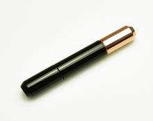 Load image into Gallery viewer, A Franklin-Christoph Model 25 pocket Fountain Pen - Copper Black SE rests diagonally on a plain white background.